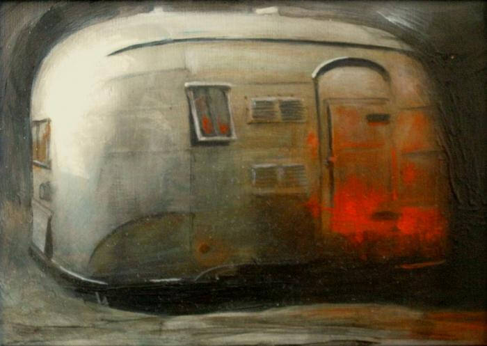 Image of a metal camper with light reflected on it.